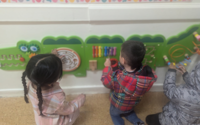 Students use the tactical board in the alligator shaped sensory hallway at LaMonte.